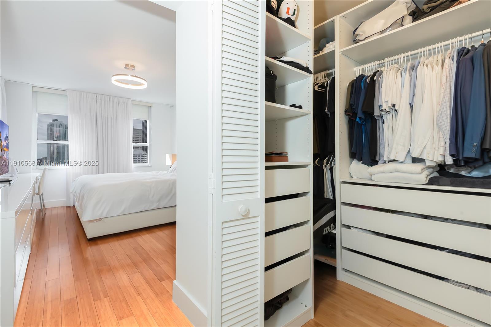 701 Brickell Key Boulevard, Unit 1912 Miami, FL 33131 - Photo 27 of 67 a bedroom with a bed and a night stand