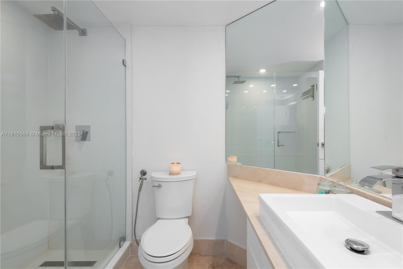 701 Brickell Key Boulevard, Unit 1912 Miami, FL 33131 - Photo 29 of 67 a bathroom with a sink a toilet and shower