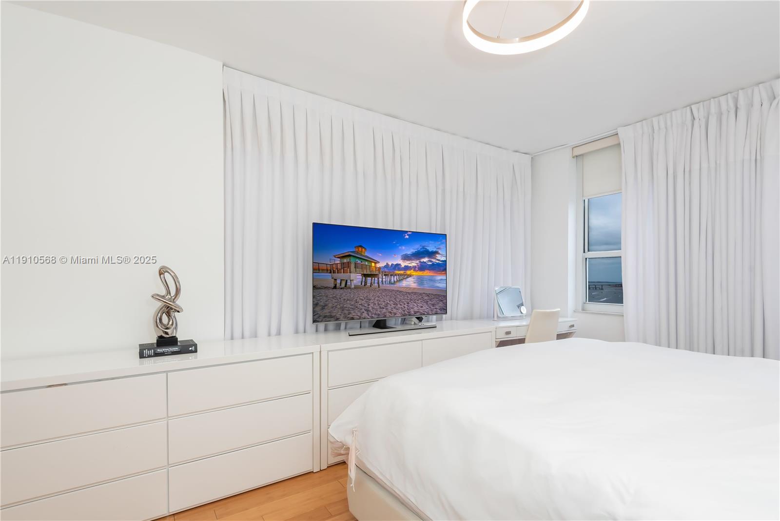 701 Brickell Key Boulevard, Unit 1912 Miami, FL 33131 - Photo 30 of 67 a bathroom with a sink and a mirror