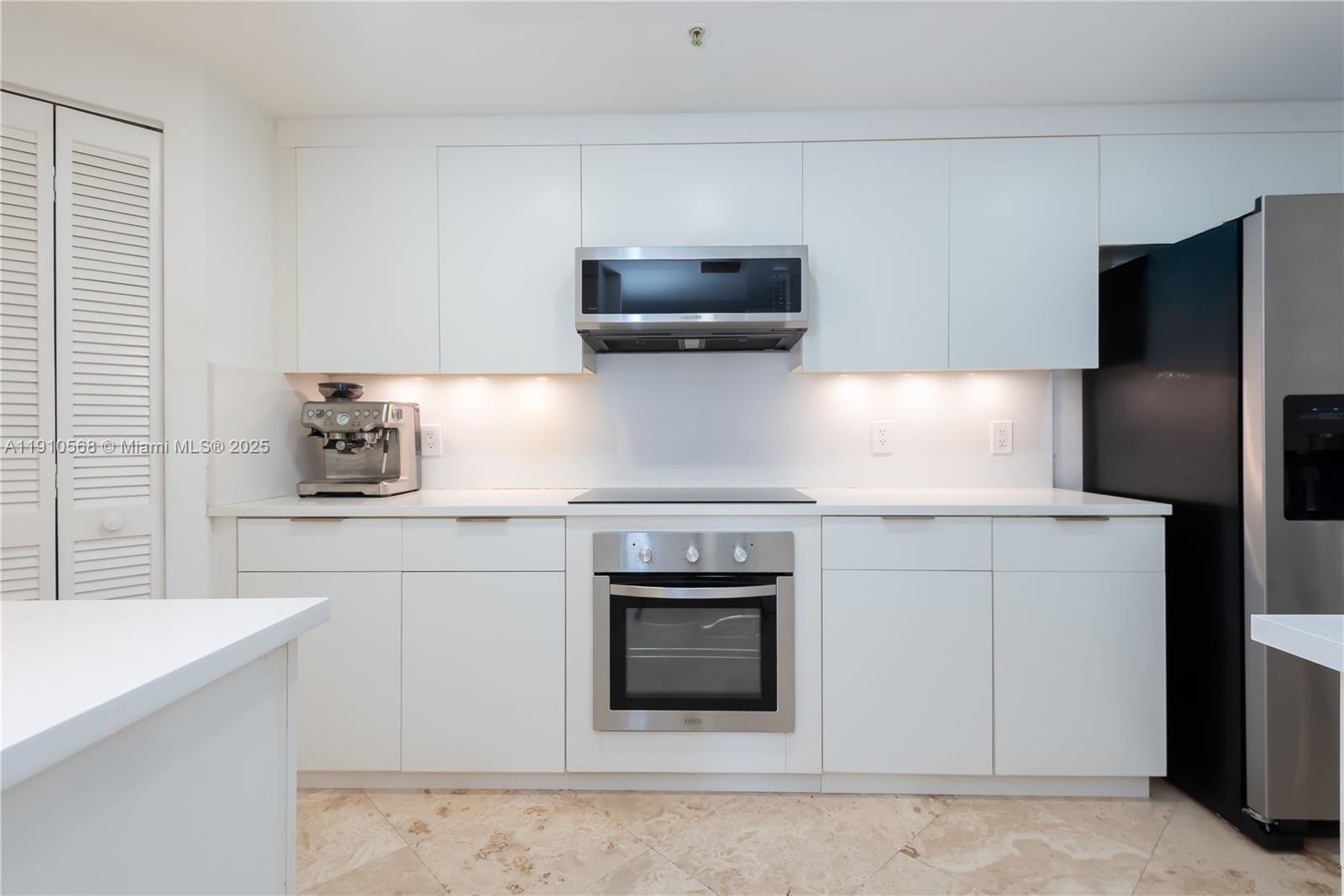 701 Brickell Key Boulevard, Unit 1912 Miami, FL 33131 - Photo 34 of 67 a kitchen with cabinets stainless steel appliances and a sink