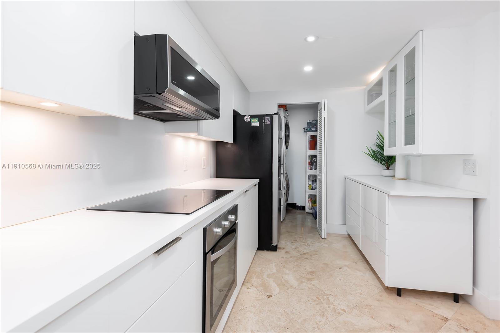 701 Brickell Key Boulevard, Unit 1912 Miami, FL 33131 - Photo 36 of 67 a kitchen with stainless steel appliances granite countertop a sink and a stove top oven