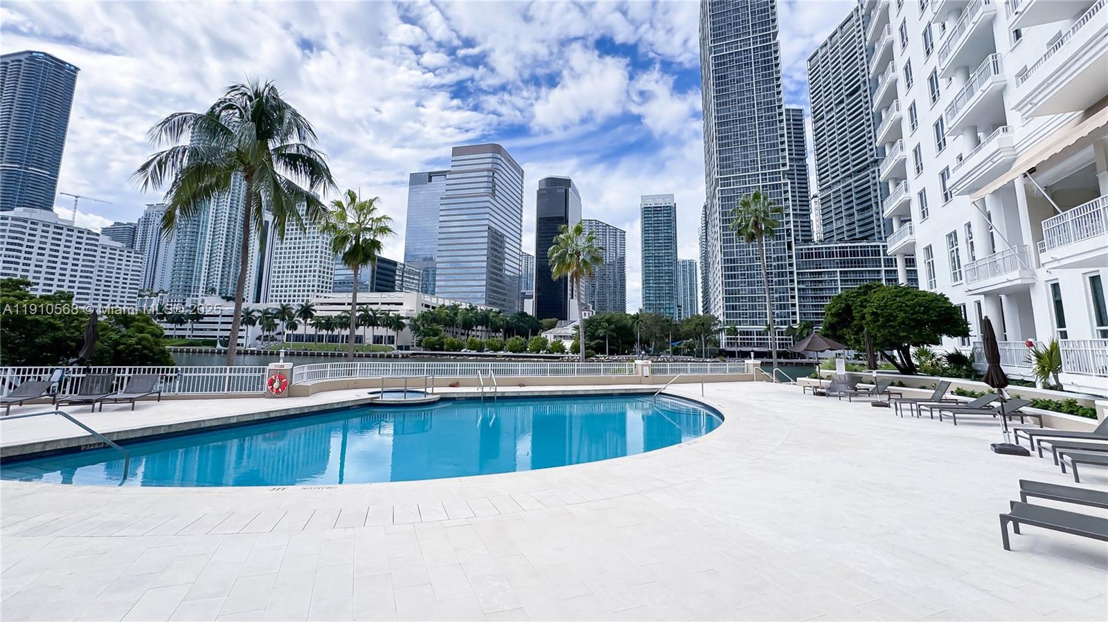 701 Brickell Key Boulevard, Unit 1912 Miami, FL 33131 - Photo 65 of 67 a swimming pool with outdoor seating and yard