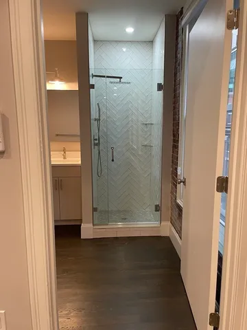 a bathroom with a glass shower door