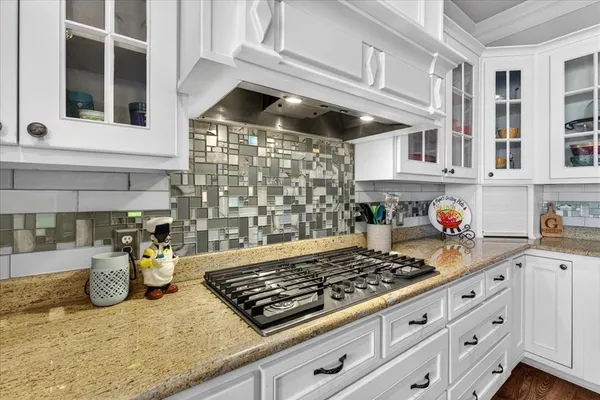 a kitchen with stove and cabinets