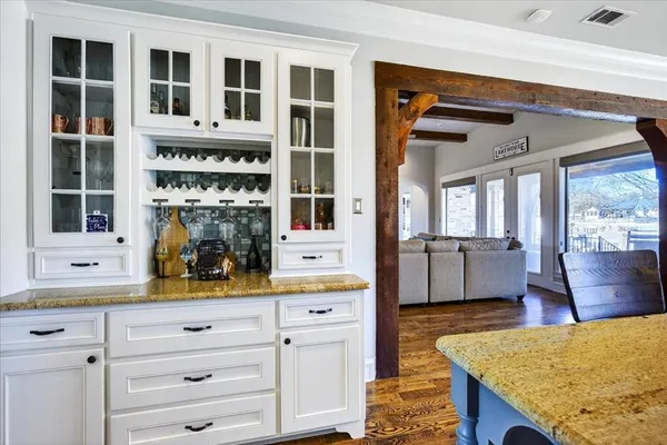 a view of living room with granite countertop cabinets and wooden floor