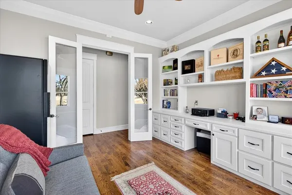 a living room with furniture cabinets and window