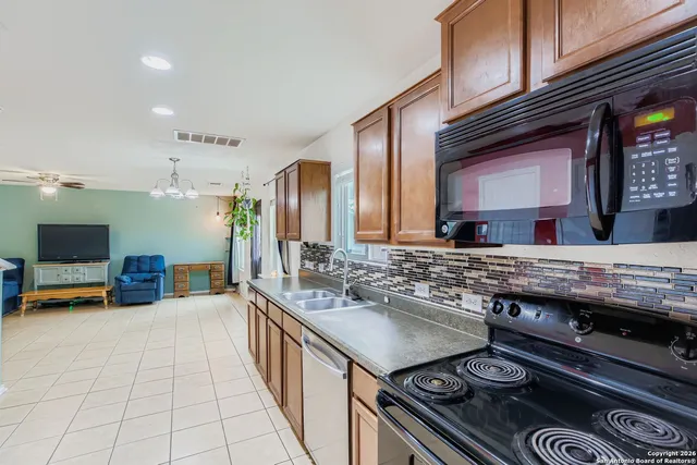 a kitchen with stainless steel appliances a stove and cabinets