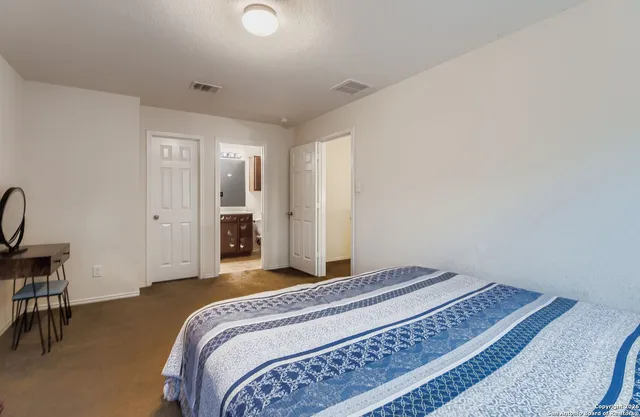 a bedroom with a bed and a desk