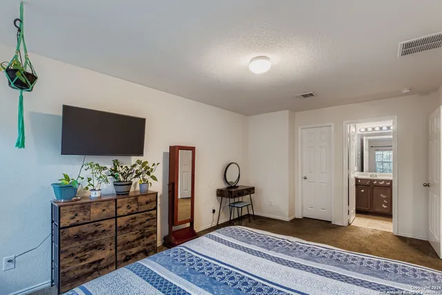 a bedroom with furniture and flat screen tv