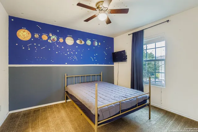 a bedroom with a bed and a window