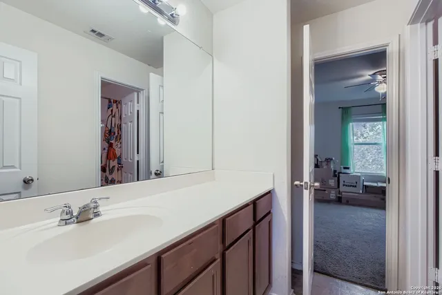a en suite bathroom with a sink and a mirror