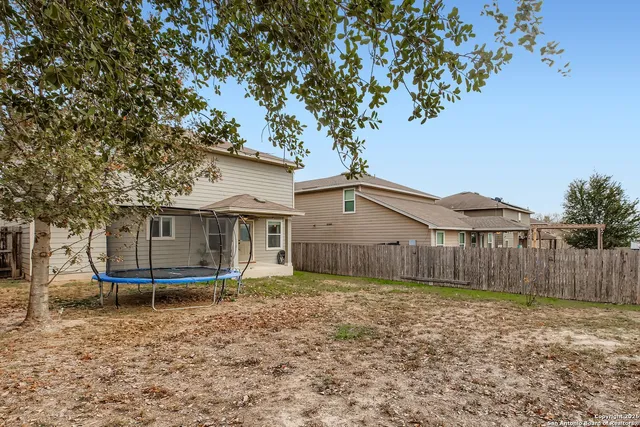 a house that has a tree in front of it