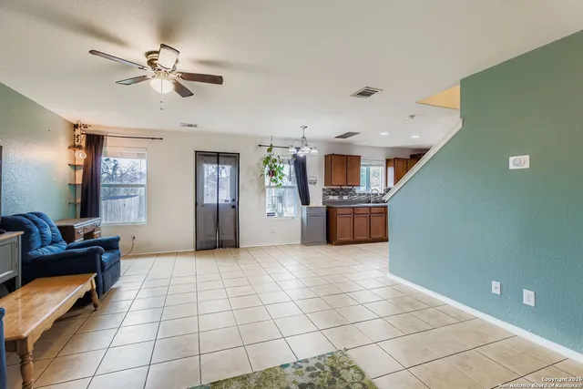 a view of a livingroom with furniture and a ceiling fan