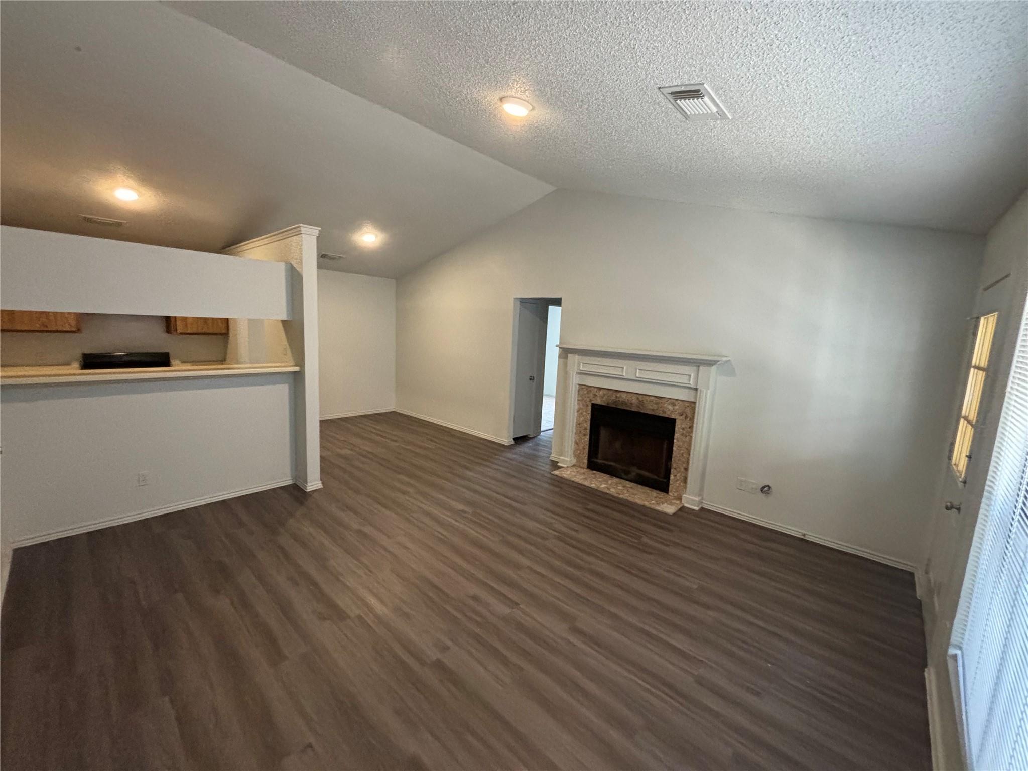 2033 Redwing Way Round Rock, TX 78664 - Photo 2 of 13 Spacious room with vaulted ceilings and wood-finish flooring