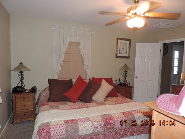 212 Maxeys Road Dillwyn, VA 23936 - Photo 8 of 20 a bedroom with a bed and a chandelier
