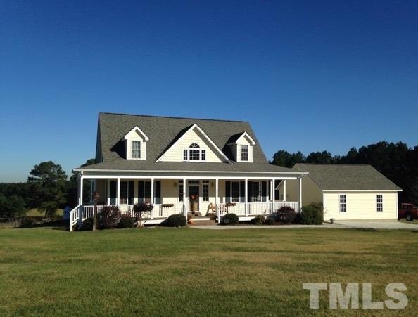 4678 Elevation Road Benson, NC 27504 - Photo 1 of 21 a front view of a house with a garden