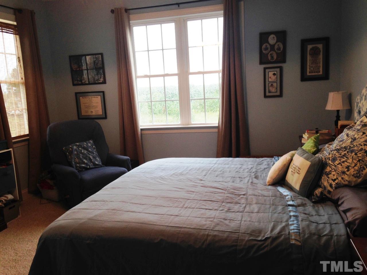 4678 Elevation Road Benson, NC 27504 - Photo 7 of 21 a bedroom with a bed and wooden floor