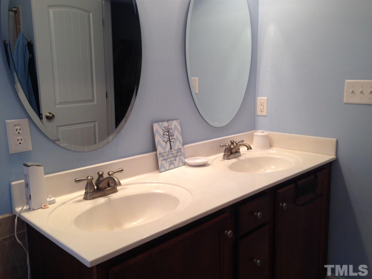 4678 Elevation Road Benson, NC 27504 - Photo 9 of 21 a bathroom with a sink vanity and a mirror