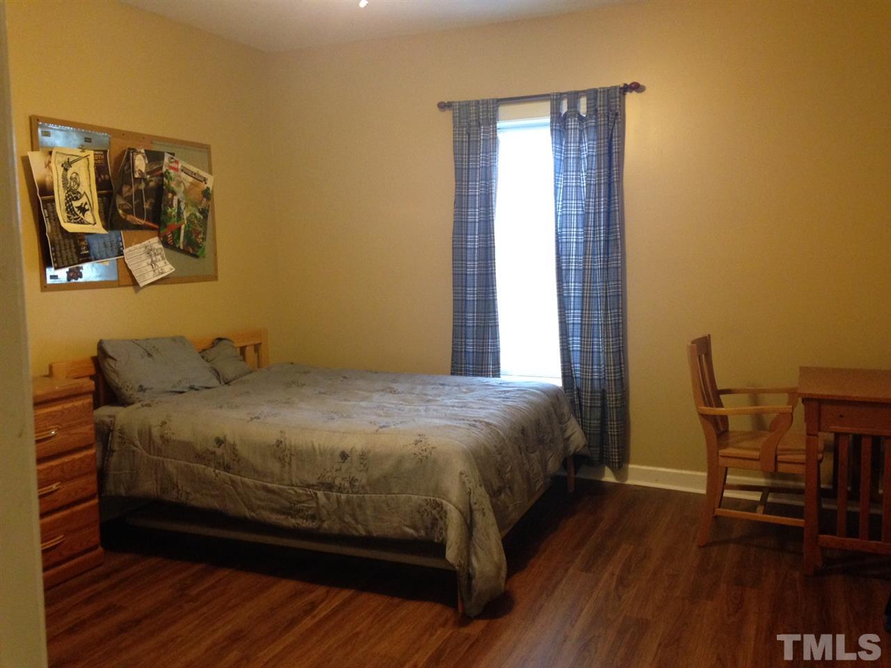 4678 Elevation Road Benson, NC 27504 - Photo 10 of 21 a bed sitting in a bedroom next to a window