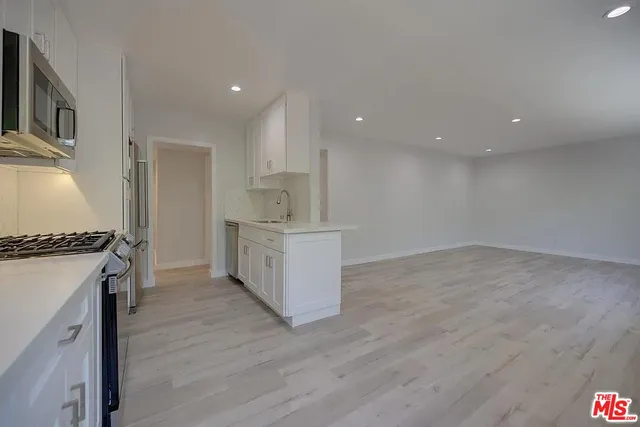 a kitchen with a stove and a refrigerator