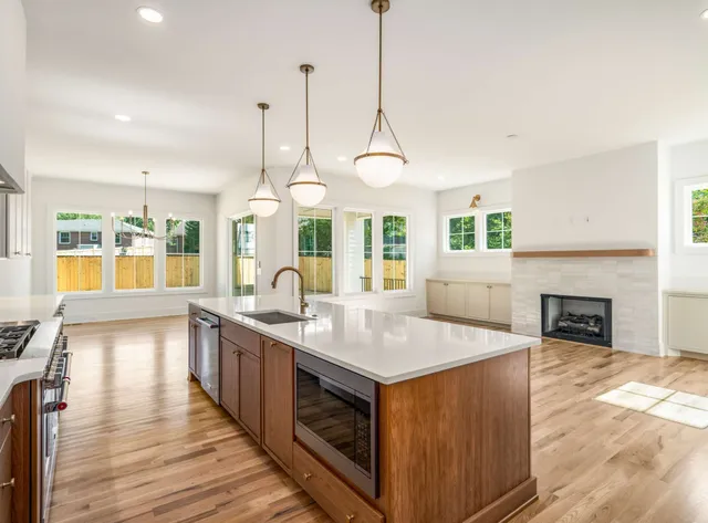 a kitchen with stainless steel appliances granite countertop a stove and kitchen island