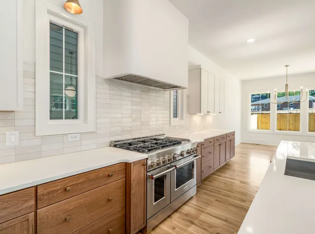 a kitchen with stainless steel appliances granite countertop a stove and a sink