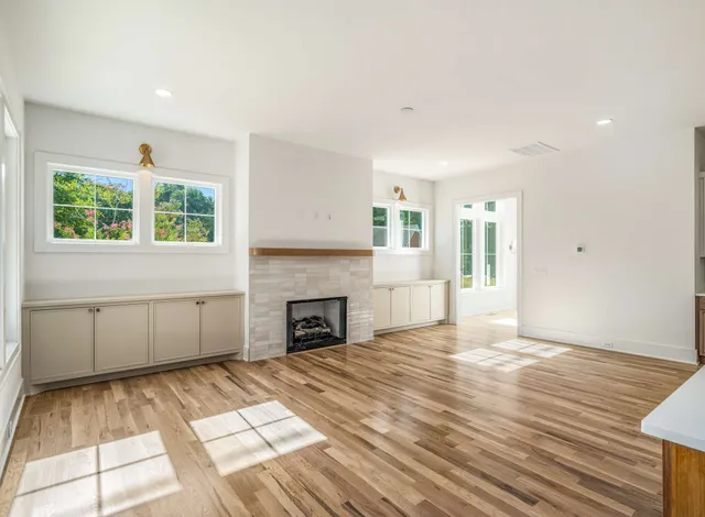 a view of empty room with windows and fireplace