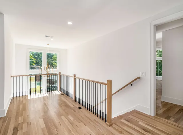 a view of a room with wooden floor and windows