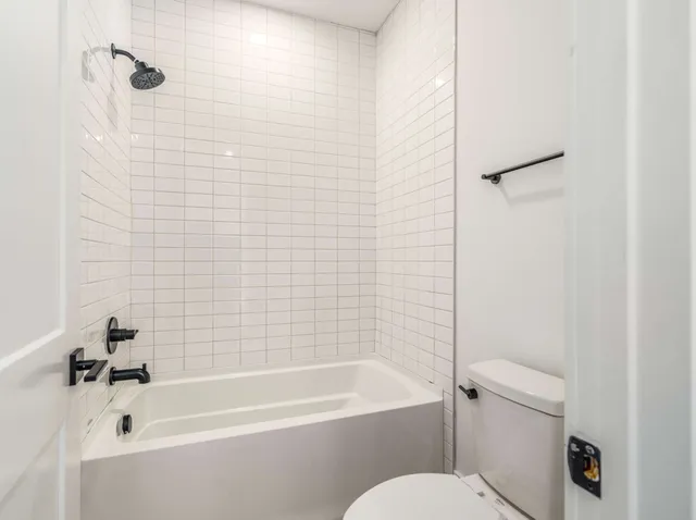 a bathroom with a bathtub and a toilet