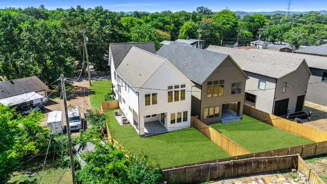 an aerial view of a house with swimming pool and garden