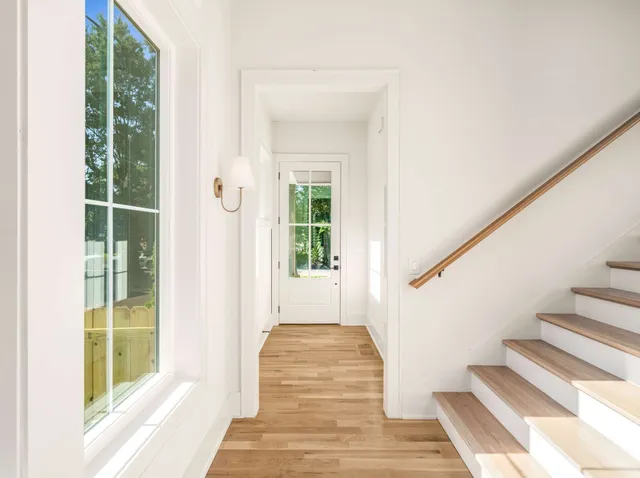 a view of entryway with wooden floor and windows