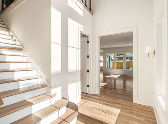 a view of an entryway with wooden floor and a rug