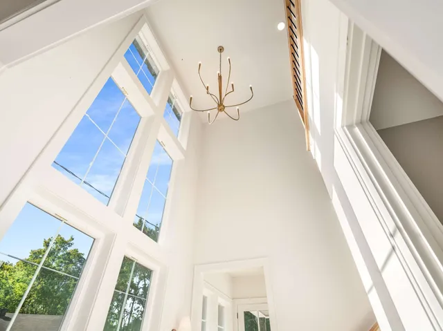 a view of a living room with a floor to ceiling window and stairs