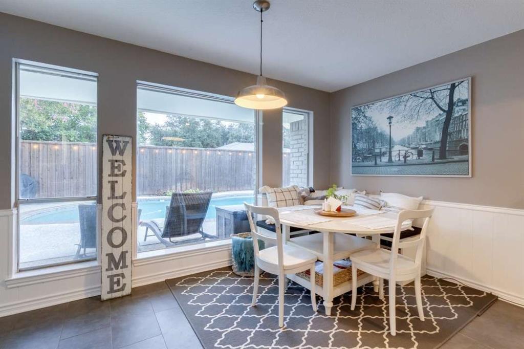 2628 Dalgreen Court Plano, TX 75075 - Photo 11 of 27 a dining room with furniture a chandelier and wooden floor