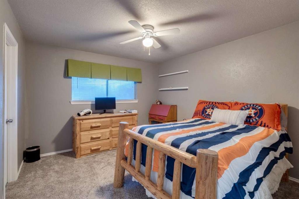2628 Dalgreen Court Plano, TX 75075 - Photo 19 of 27 a bedroom with two beds and a ceiling fan