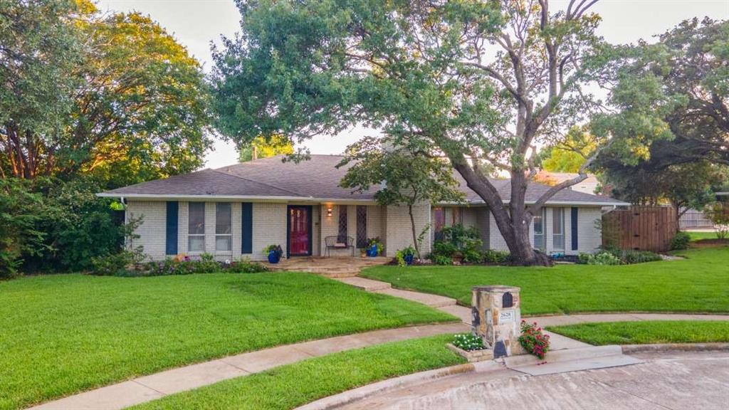 2628 Dalgreen Court Plano, TX 75075 - Photo 2 of 27 a front view of a house with a garden and trees