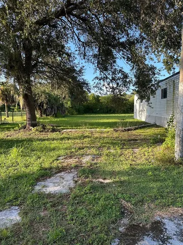 a view of field with trees in the background