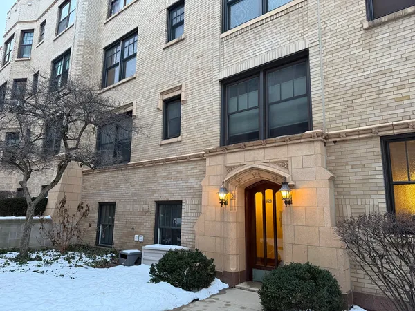 a view of a brick house with large windows