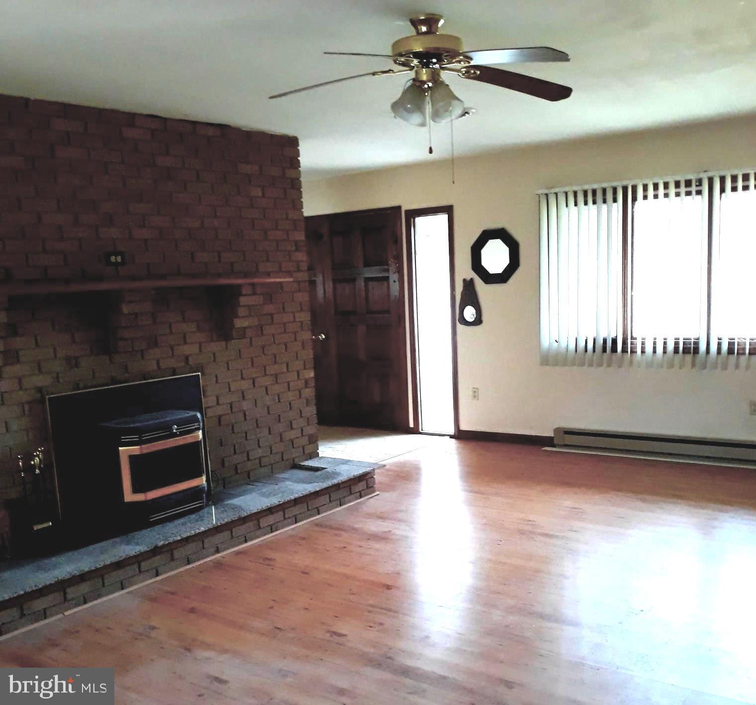 407 Stony Lane Ranson, WV 25438 - Photo 29 of 52 PELLET STOVE IN LARGE LIVING ROOM