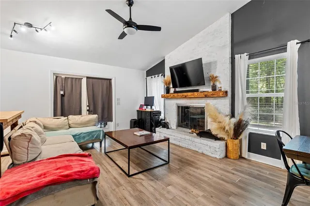 a living room with furniture fireplace and flat screen tv
