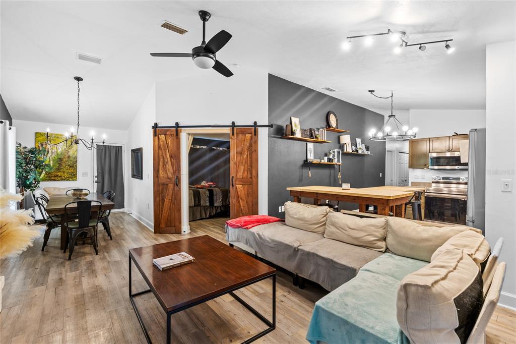 5309 Northeast 60th Avenue High Springs, FL 32643 - Photo 15 of 34 a living room with furniture kitchen view and a chandelier
