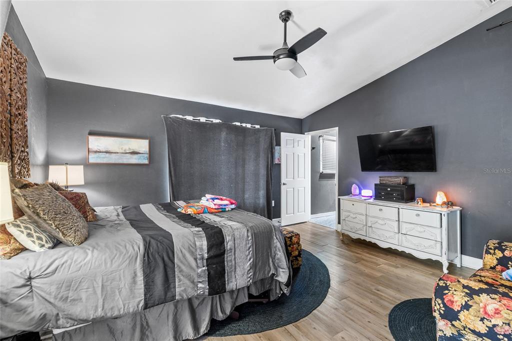 5309 Northeast 60th Avenue High Springs, FL 32643 - Photo 17 of 34 a bedroom with a bed and a flat screen tv