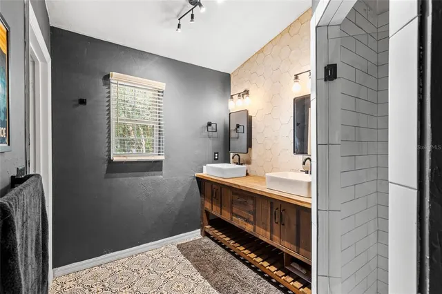 a bathroom with a sink a vanity and a mirror