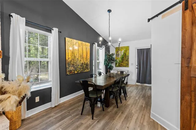 a view of a dining room with furniture window and wooden floor