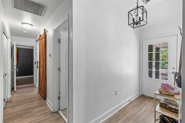 a view of hallway with wooden floor and stairs