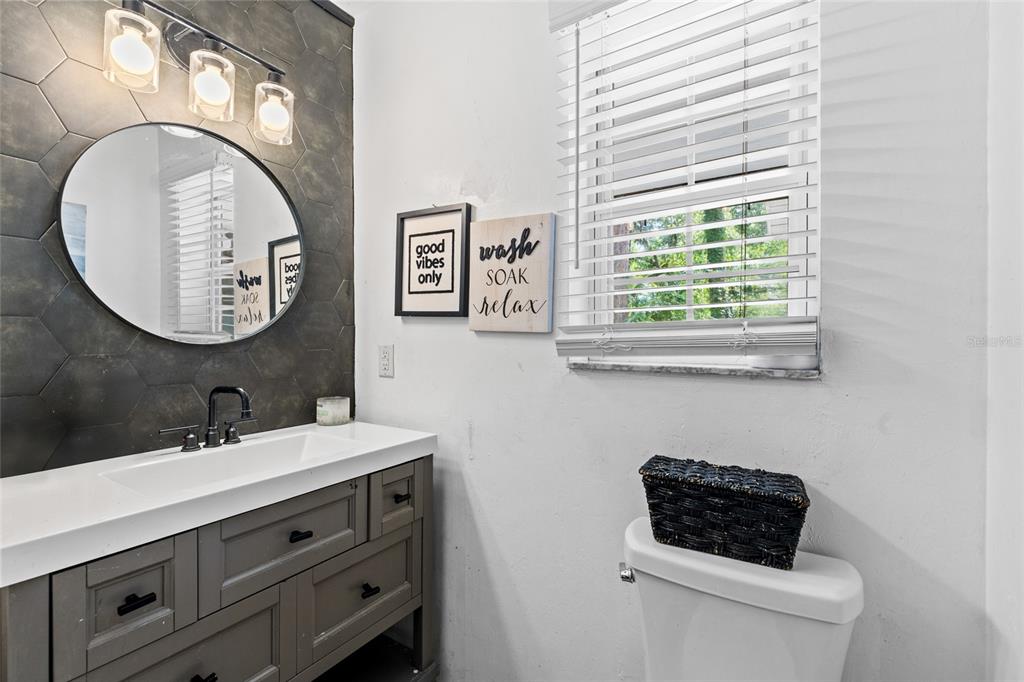 5309 Northeast 60th Avenue High Springs, FL 32643 - Photo 24 of 34 a bathroom with a toilet a sink and mirror