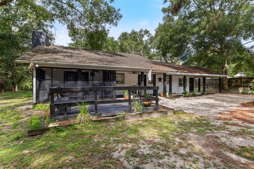 5309 Northeast 60th Avenue High Springs, FL 32643 - Photo 28 of 34 a view of house with wooden deck and furniture