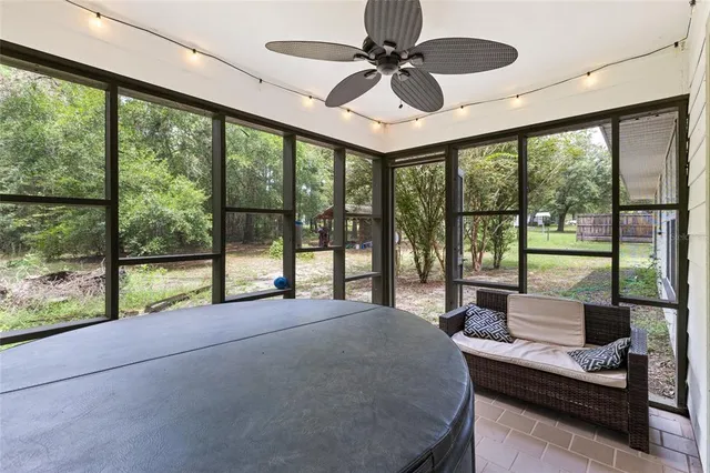 a bedroom with furniture and large windows