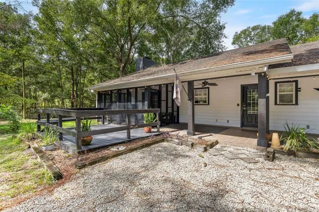 a view of a house with backyard and sitting area
