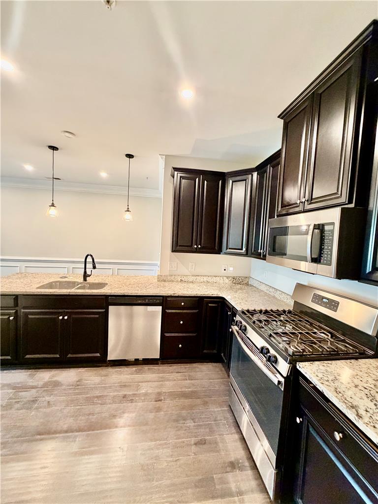 4758 Rafi Road Easton, PA 18045 - Photo 12 of 57 Dark wood cabinetry and stone countertops accent this modern cooking space with recessed lighting.
